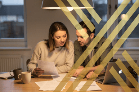 A couple is seated at a modern dining table in a UK home, reviewing legal paperwork and discussing their legal rights and financial arrangements as common law partners.