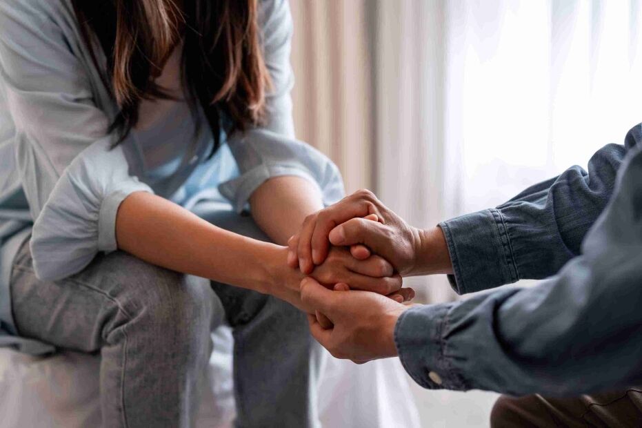 Lady Justice statue on a desk, with sunlight streaming through a window, creating a serene atmosphere.
